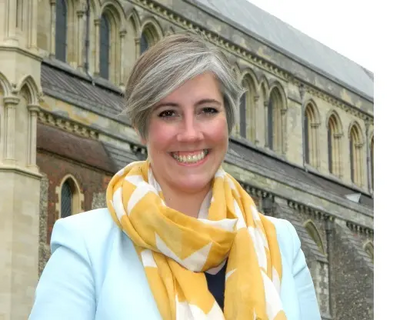 Daisy Cooper in front of St Albans Cathedral